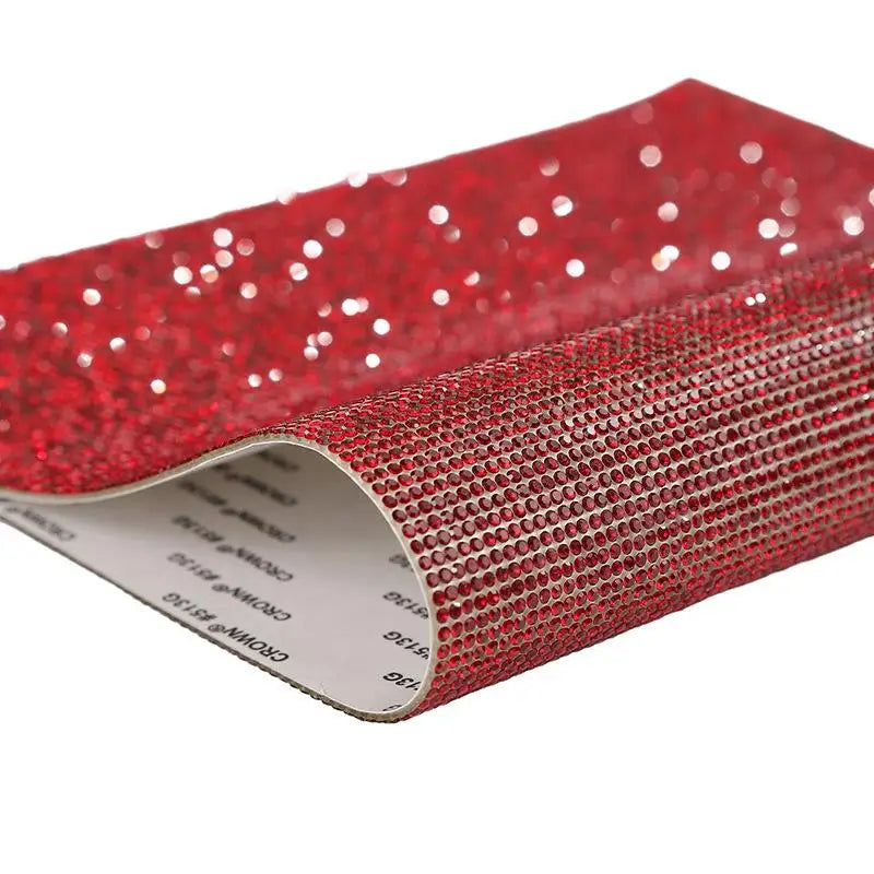 Red sparkling rhinestone adhesive tape rolled up for DIY crafts and decor
