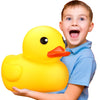A young boy is holding a bright yellow rubber duck toy.