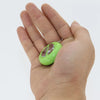 A hand is holding a bright lime green electric shock hand buzzer prank toy.