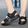 A pair of black non-slip summer sport sandals worn on a person's foot.