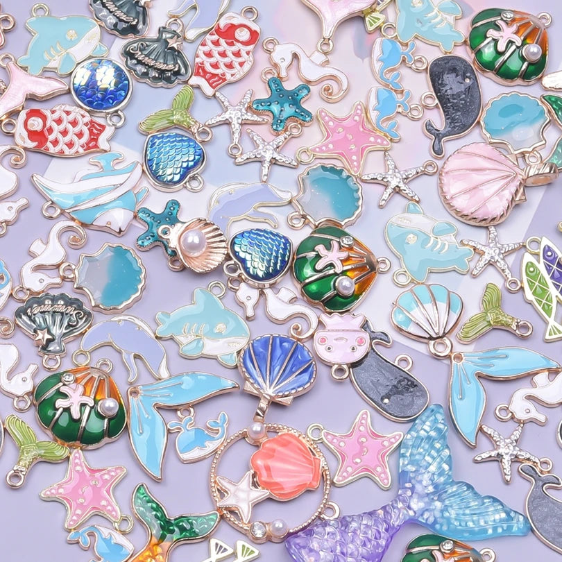 Assortment of gold-tone enamel charms for jewelry making featuring various shapes and colors