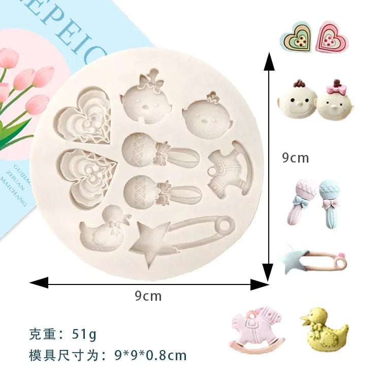 A set of silicone baby-themed cake molds including a pacifier, bottle, and various shapes for baby accessories.