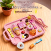 A pink dinner plate design tray filled with various food-themed pretend play items like fruit and utensils.