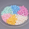 A clear plastic container filled with various colored plastic beads for DIY squishy toys and stress relief crafts