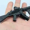 A black 1:6 scale MP5SD5 submachine gun model kit resting on a person's hand.