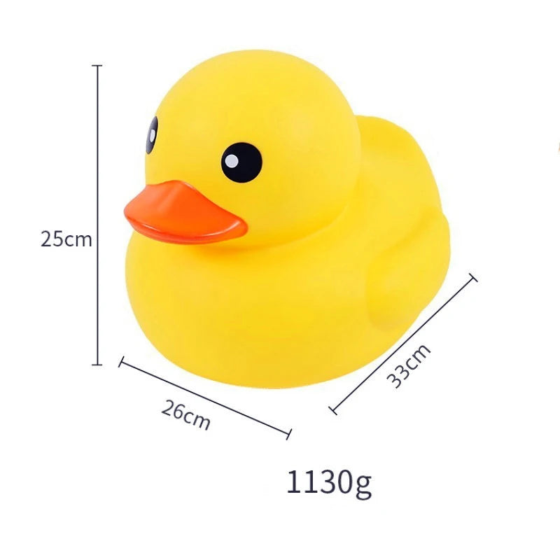 A bright yellow rubber duck with an orange beak and black eyes, shown next to dimension markings.