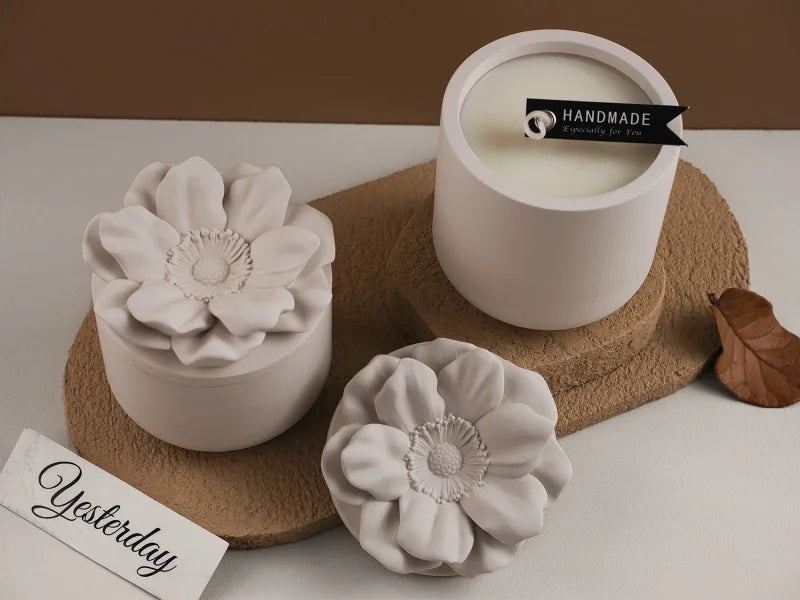 A white ceramic cup filled with cream-colored wax, next to a floral silicone mold and a wooden surface.