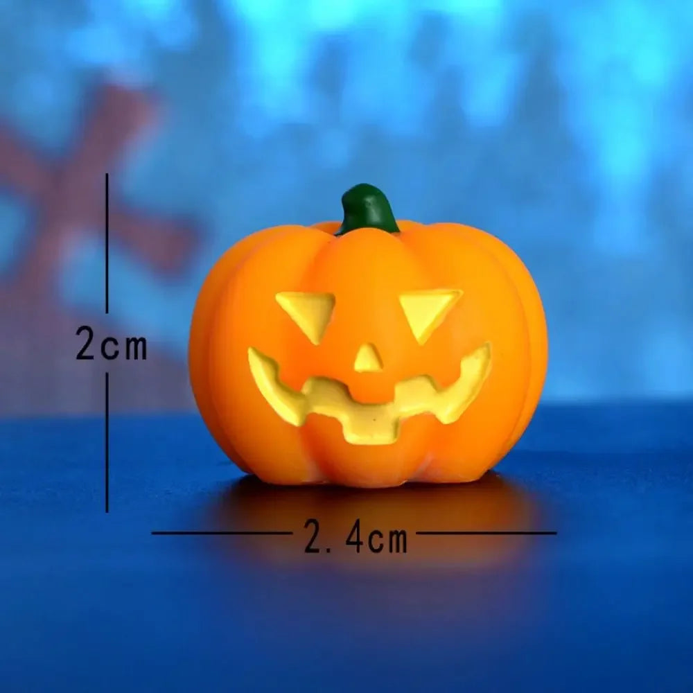 An orange carved pumpkin figurine with a smiling face and green stem, displayed on a blue surface.