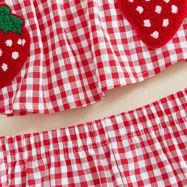 A red and white plaid fabric set featuring strawberry embroidery for a toddler girl