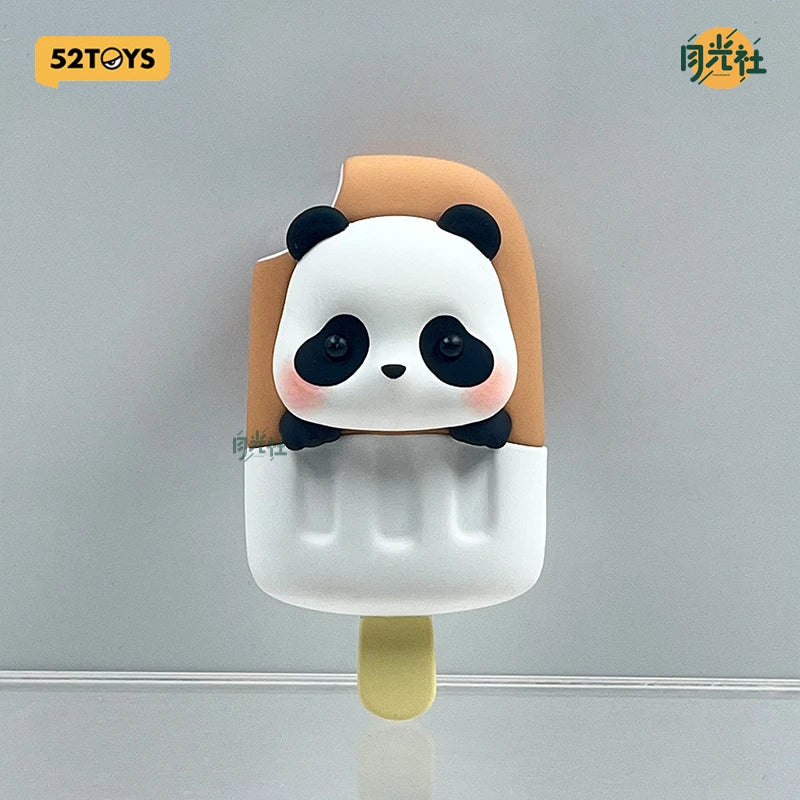 A blind box collectible figure of a panda face with white fur and black markings, mounted on a light beige cylindrical base.