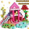 A pink and green magnetic building block set featuring a house structure and various colored blocks.