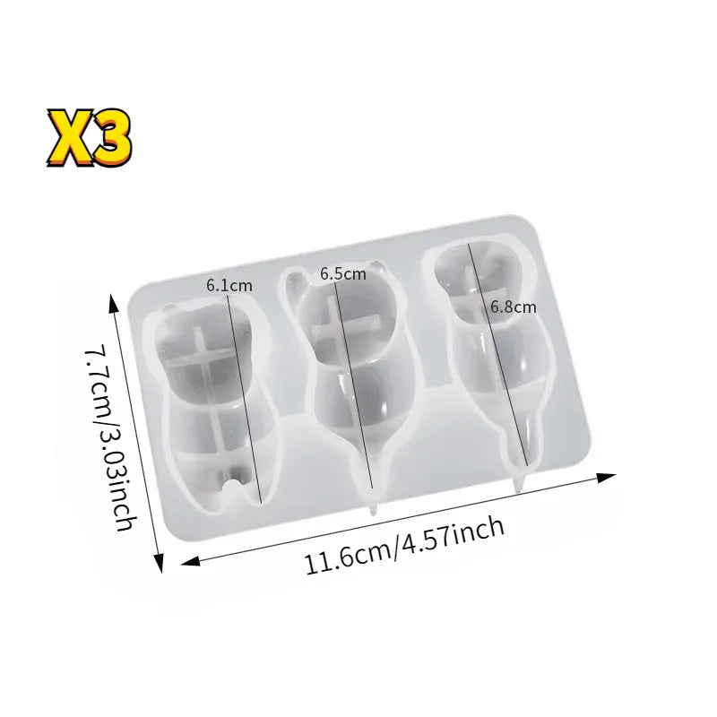 A white silicone mold with three cavities for making keychains, pendants, or pen holders.