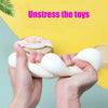 Hands squeezing a white dumpling squishy stress relief toy against a yellow background.