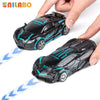 A hand holds a black and blue transformable robot sports car toy for kids.