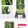 A green universal stroller rain cover with a front door and zipper, shown in various views.