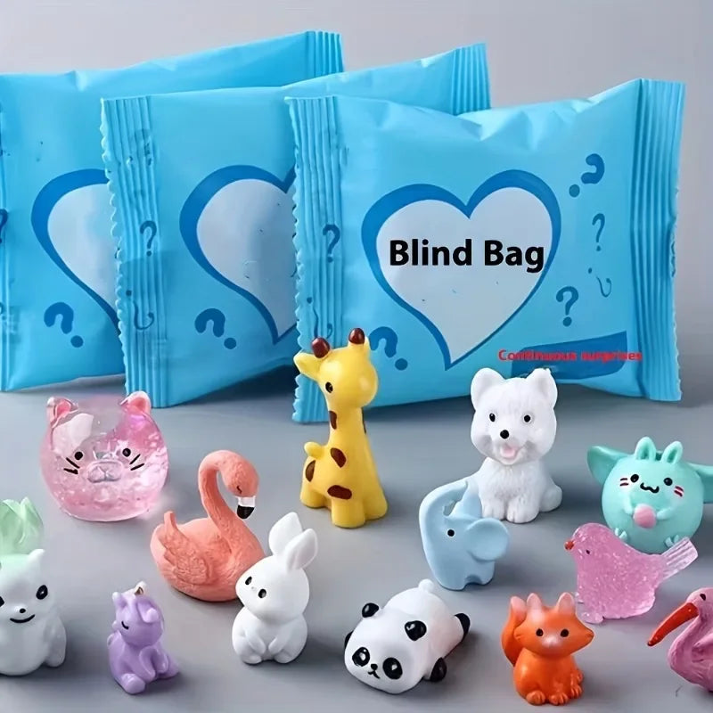 A collection of cute mini animal surprise blind bags in various colors and shapes displayed on a gray surface.