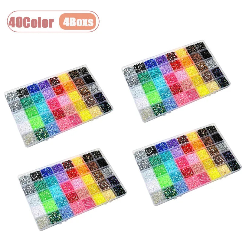 A flat back rhinestone gem set with tools featuring 40 colors arranged in a grid for nail art and DIY crafts.