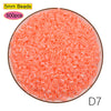 A pile of 5mm pink beads, 500 pieces, used for craft projects.