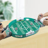 A close-up of a portable tabletop foosball game setup with green and black rods on a wooden table.