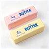 A pink butter stick labeled salted butter and a yellow butter stick labeled salted butter are shown on a white background.
