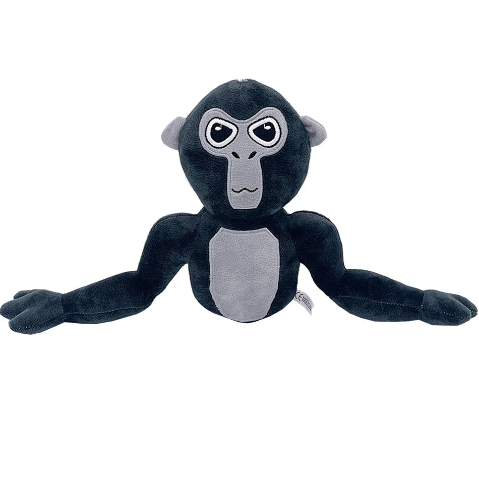 A dark gray and black plush toy of a monke gorilla with large eyes.