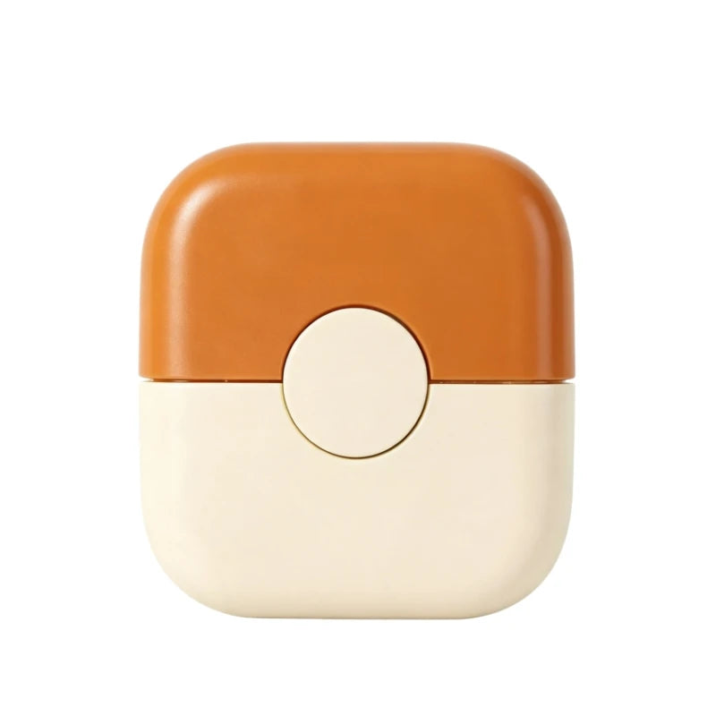 A compact, two-toned baby hair cutting comb with an orange top and a cream bottom.