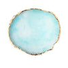 A round, pale aqua resin palette with a gold trim.