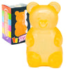 A bright yellow bear squeeze toy is shown next to its packaging box.