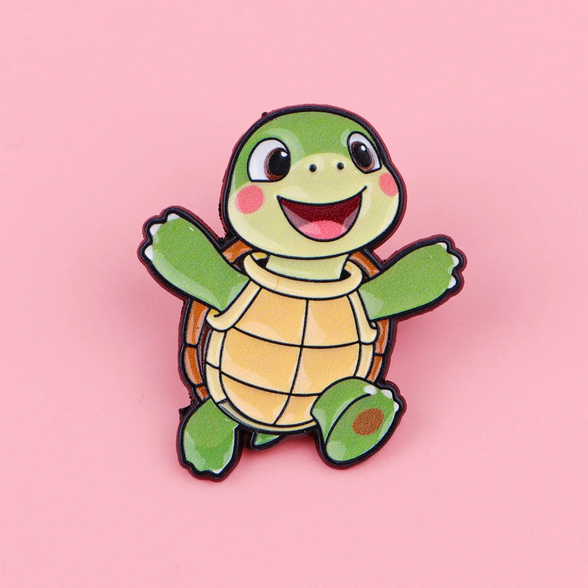 A cute green turtle enamel pin featuring a smiling face and textured shell.
