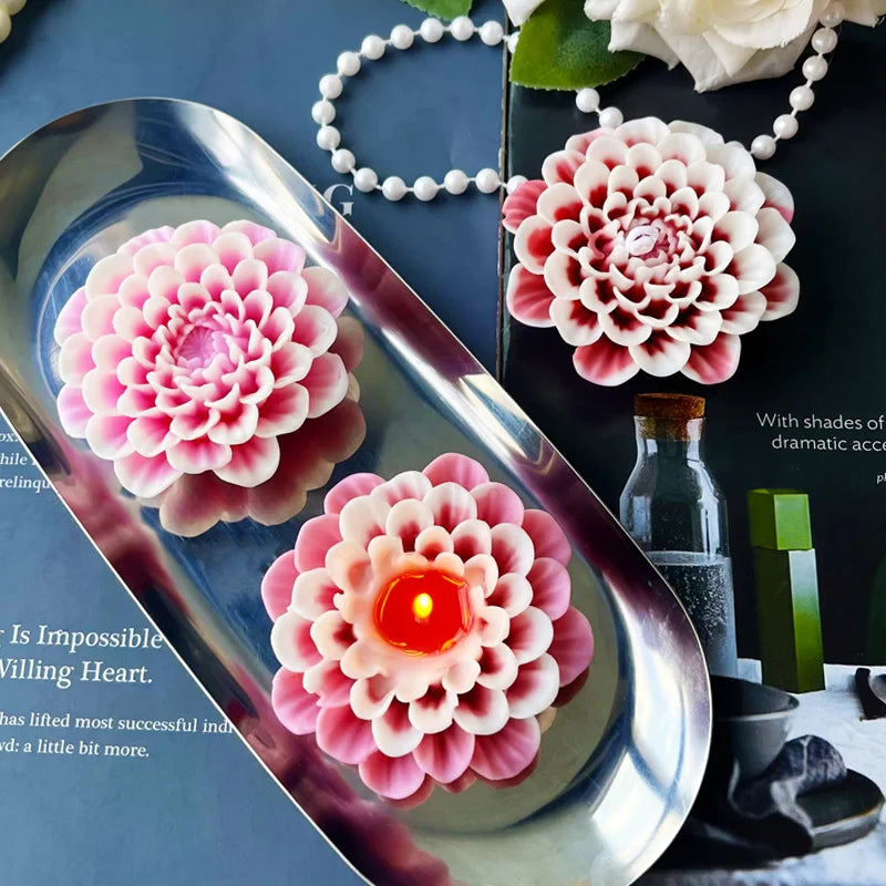 Pink flower silicone mold for crafting displayed on a silver tray with surrounding green and white elements.