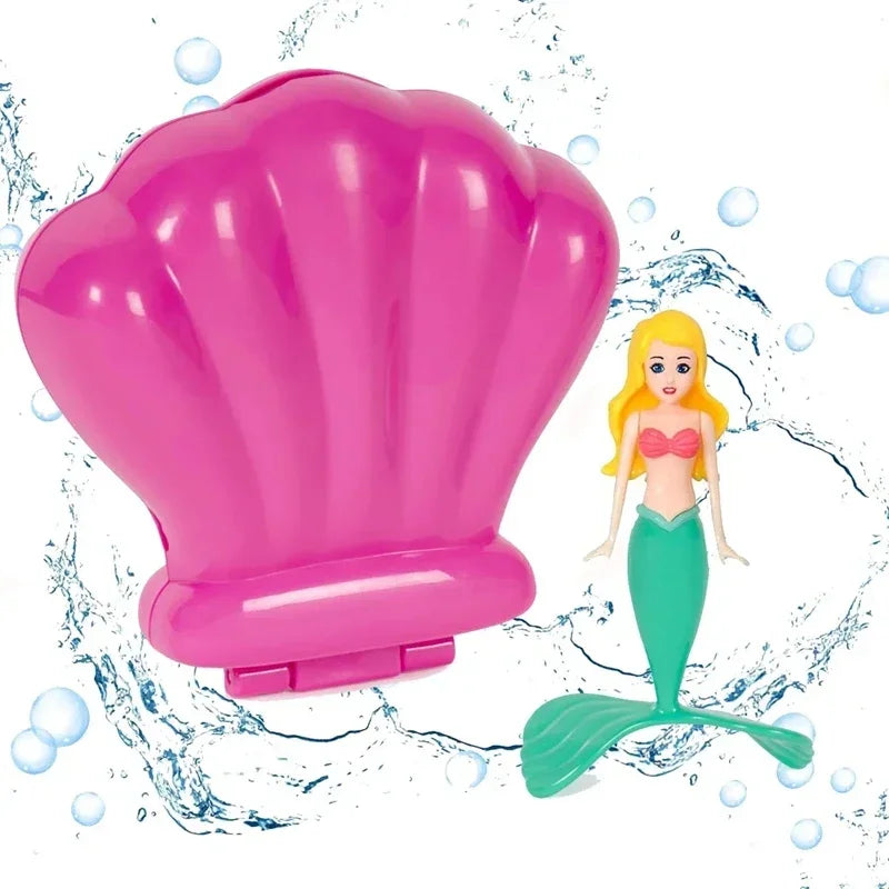 A pink mermaid dive toy shaped like an opening seashell with a green tail.