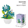 A set of 217 plastic miniature flower bouquets with green and blue petals and yellow centers in a box.