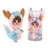 A small, pink and blue fluffy doll with brown ears is shown next to its clear plastic keychain container.