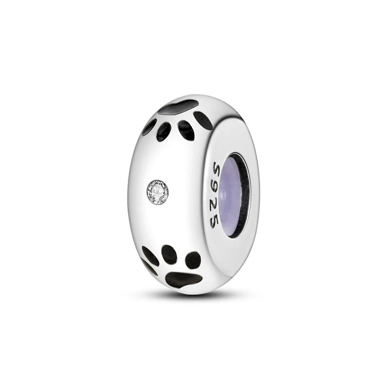 A silver charm bead with a textured surface and a purple inlay, used for DIY bracelet making.