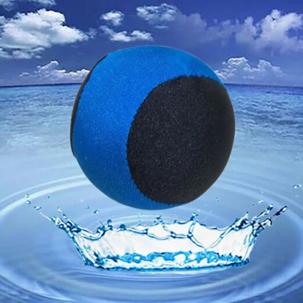 A blue and black water bouncing ball is shown splashing water in a clear pool or ocean.