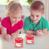 Two children are looking at a jar of red slime putty for kids.