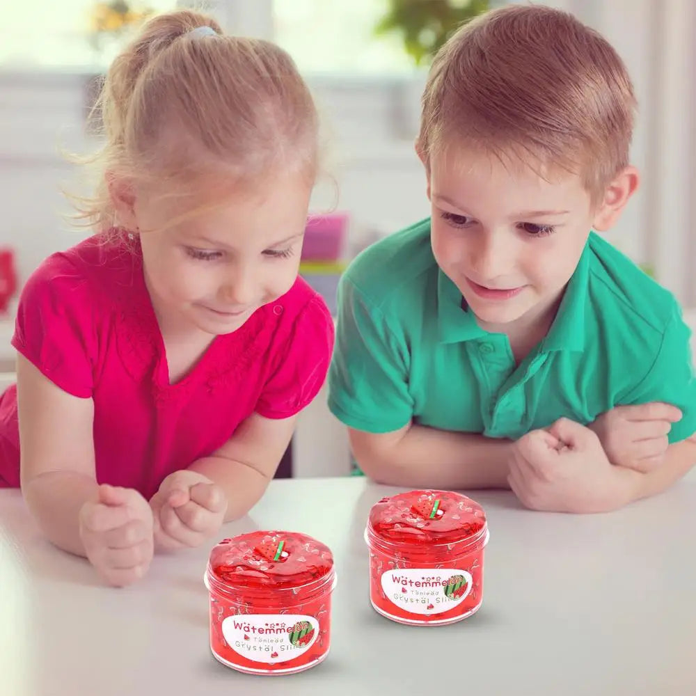 Two children are looking at a jar of red slime putty for kids.