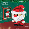 A red and white Santa figure made of micro building blocks, packaged with Christmas greenery.