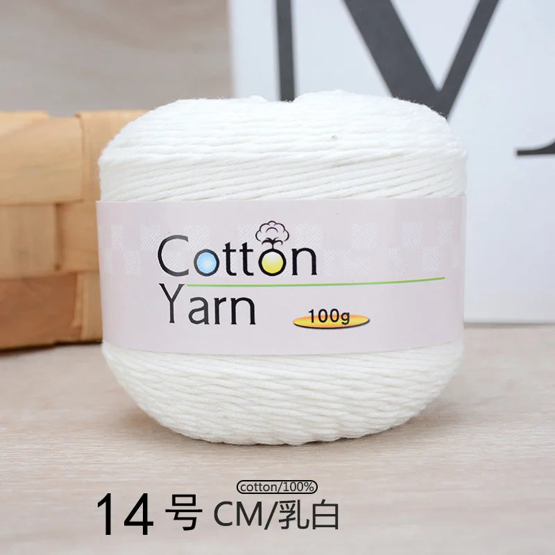 A ball of white 100% cotton yarn labeled as Cotton Yarn 100g with a measurement of 14 cm.