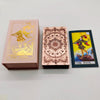 Three boxes of gold foil tarot cards with rose pink oracle finish displayed side by side.