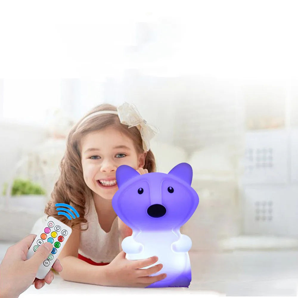 A child holds a purple LED night light shaped like a fox, which is controlled by a remote.