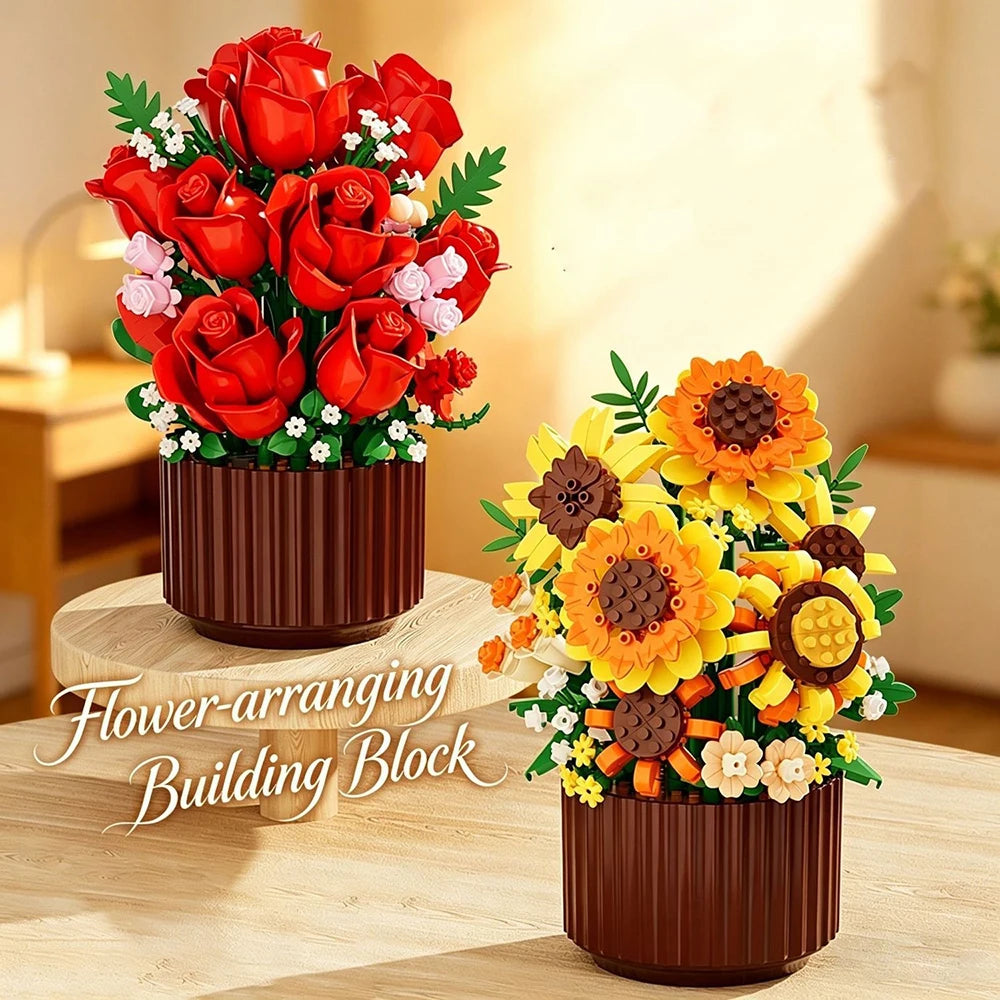 A bouquet of red roses and orange sunflowers arranged in a brown cylindrical building block pot.
