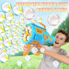A boy is playing with an orange bubble gun that shoots bubbles, surrounded by many floating bubbles.