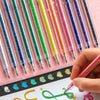 A hand is writing with a colorful glitter gel pen from a set of 1.0 mm pens on a white surface.