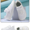 A pair of white minimalist barefoot sneakers shown from the side and top view.