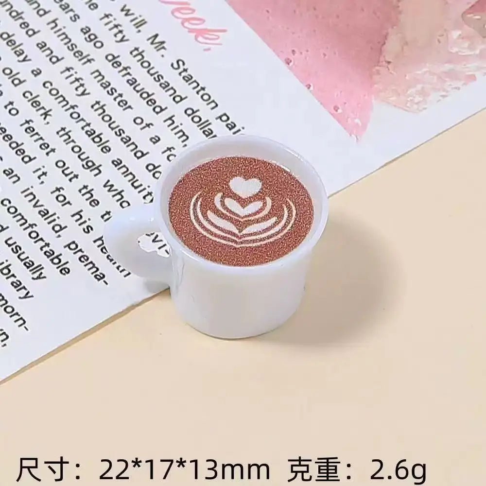 A white ceramic mug with a brown latte art design sits on a light background.