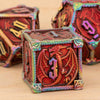 A close-up of a set of premium metal polyhedral dice, featuring red and purple iridescent finishes.