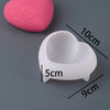 A pink heart-shaped silicone mold and a white heart-shaped mold are shown with dimension lines and weight information.