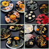 A collection of clear UV resin glue for jewelry making and crafts, featuring various floral designs on black and clear resin 