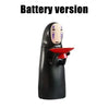A black, house-shaped piggy bank with a facial expression and a red mouth is shown.